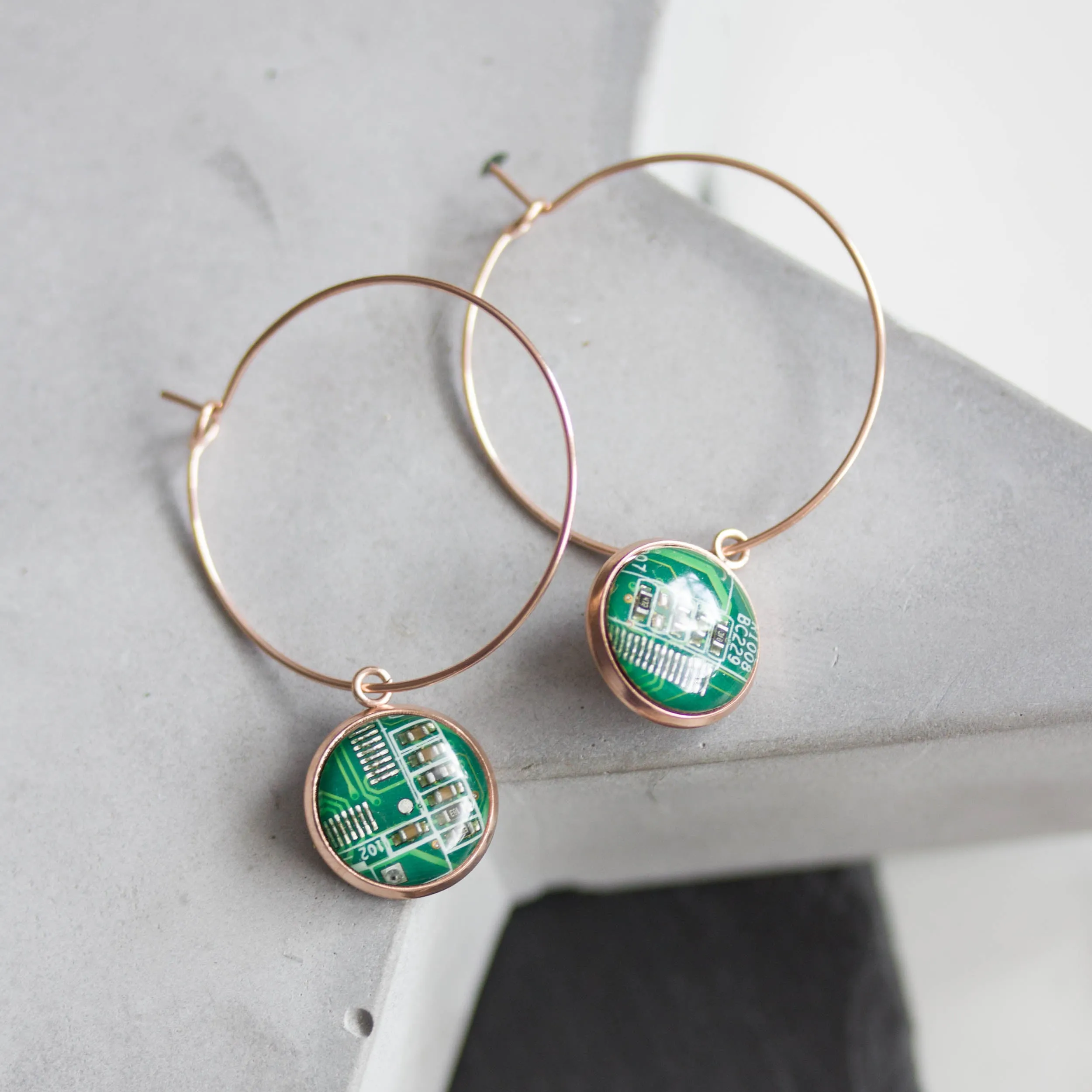 Hoop earrings with 12mm round circuit board pendants, rose gold colored wires